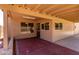 Covered patio at the back of a single-story house with a red painted concrete floor at 4336 E Aspen Ave, Mesa, AZ 85201