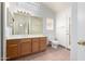 The bathroom features a white countertop, wood cabinets and a glass door to the backyard at 4336 E Aspen Ave, Mesa, AZ 85201