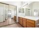 The bathroom features a white countertop, wood cabinets, and mirrored closet doors at 4336 E Aspen Ave, Mesa, AZ 85201