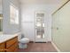 This bathroom features white walls, a toilet, and a glass door to the backyard at 4336 E Aspen Ave, Mesa, AZ 85201