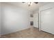 A bright bedroom is shown with a ceiling fan, closet, and an open doorway at 4336 E Aspen Ave, Mesa, AZ 85201