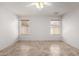 An empty room features tan tile flooring and windows overlooking the exterior at 4336 E Aspen Ave, Mesa, AZ 85201