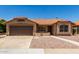 Single story home featuring a brown two car garage, tile roof, desert landscaping, and sidewalk leading to the front door at 4336 E Aspen Ave, Mesa, AZ 85201