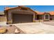 Single story home featuring a brown two car garage, tile roof, desert landscaping, and sidewalk leading to the front door at 4336 E Aspen Ave, Mesa, AZ 85201