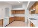 Kitchen featuring white countertops, wood cabinetry, and white appliances at 4336 E Aspen Ave, Mesa, AZ 85201