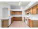 Spacious kitchen features tile floors, wood cabinets, and white appliances at 4336 E Aspen Ave, Mesa, AZ 85201