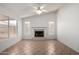 Spacious living room featuring tile floors, white walls, and a fireplace at 4336 E Aspen Ave, Mesa, AZ 85201