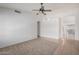 Spacious living room featuring tile/carpet flooring, white walls and ceiling fan at 4336 E Aspen Ave, Mesa, AZ 85201