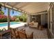 Inviting covered back patio with a pool view and stylish outdoor seating area perfect for relaxing or entertaining guests at 5438 E Avalon Dr, Phoenix, AZ 85018