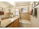 Tiled bathroom with vanity, granite countertop and shower over tub combination at 5438 E Avalon Dr, Phoenix, AZ 85018