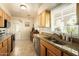 Bright kitchen with stainless steel appliances, double sink, granite countertops and natural wood cabinets at 5438 E Avalon Dr, Phoenix, AZ 85018