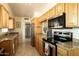 Well-equipped kitchen with stainless steel appliances, granite countertops, and ample cabinet space at 5438 E Avalon Dr, Phoenix, AZ 85018