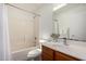 Bathroom features tile shower and tub, vanity, large mirror, and white towels at 6515 W Hughes Dr, Phoenix, AZ 85043