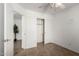 Bright bedroom features a ceiling fan, neutral paint, open closet, and doorway at 6515 W Hughes Dr, Phoenix, AZ 85043