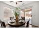 Cozy dining room featuring a wooden table, seating for four, and natural light at 6515 W Hughes Dr, Phoenix, AZ 85043