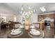 Bright and inviting dining area showcasing a dark wood table with stylish tableware at 6515 W Hughes Dr, Phoenix, AZ 85043