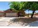 Welcoming single-story home with a well-maintained lawn and a convenient two-car garage at 6515 W Hughes Dr, Phoenix, AZ 85043