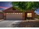Charming single-story home with a two car garage and desert landscaping at 6515 W Hughes Dr, Phoenix, AZ 85043