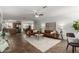 Bright living room featuring stylish brown couches, a ceiling fan, and neutral decor at 6515 W Hughes Dr, Phoenix, AZ 85043