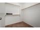 Empty walk-in closet with wood shelving and neutral carpeting at 6515 W Hughes Dr, Phoenix, AZ 85043