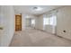 Neutral carpeted bedroom with mirrored closet, built-in cabinets, and natural light from a window at 6960 W Peoria Ave # 74, Peoria, AZ 85345