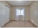 Cozy bedroom features neutral carpet, closet, and a window for natural light at 6960 W Peoria Ave # 74, Peoria, AZ 85345