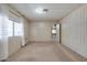 Neutral carpeted bedroom with natural light and a door to another room at 6960 W Peoria Ave # 74, Peoria, AZ 85345