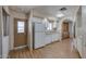Bright kitchen with wood-look flooring, white cabinets, stainless sink, and a side door to a laundry area at 6960 W Peoria Ave # 74, Peoria, AZ 85345