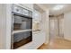 Cozy kitchen with vintage oven and cooktop, white cabinetry, and wood-style flooring at 6960 W Peoria Ave # 74, Peoria, AZ 85345