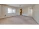 Comfortable living room with neutral carpet, light walls, and natural light with a view through the windows at 6960 W Peoria Ave # 74, Peoria, AZ 85345