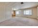 Spacious living room with neutral carpet, light walls, and abundant natural light from the large windows at 6960 W Peoria Ave # 74, Peoria, AZ 85345