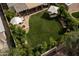 Aerial view of backyard featuring lawn, fire pit area, hammock, mature trees and privacy at 8068 E Del Trigo Rd, Scottsdale, AZ 85258