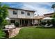 Inviting backyard featuring a covered patio, comfortable seating, and a lush green lawn perfect for outdoor relaxation at 8068 E Del Trigo Rd, Scottsdale, AZ 85258