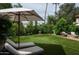 Expansive backyard featuring manicured lawn, lounge chairs, umbrella and patio area at 8068 E Del Trigo Rd, Scottsdale, AZ 85258