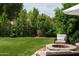 Beautiful backyard with artificial turf, firepit and inviting seating area at 8068 E Del Trigo Rd, Scottsdale, AZ 85258