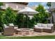 Outdoor backyard patio with a stone fire pit surrounded by ample seating at 8068 E Del Trigo Rd, Scottsdale, AZ 85258
