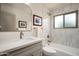 Bright bathroom with tub and shower combination, gray vanity, neutral walls, and a modern mirror at 8068 E Del Trigo Rd, Scottsdale, AZ 85258
