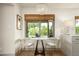 Bright dining area with a marble table, modern chairs, and a decorative chandelier at 8068 E Del Trigo Rd, Scottsdale, AZ 85258
