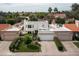 Aerial view of modern home showcasing well-manicured landscaping and private entry gate at 8068 E Del Trigo Rd, Scottsdale, AZ 85258