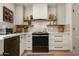 Well-lit kitchen with stainless steel appliances, stone countertops, and decorative pottery at 8068 E Del Trigo Rd, Scottsdale, AZ 85258