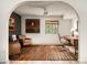 Office space featuring wood floors, a ceiling fan, modern art, and a window with natural light at 8068 E Del Trigo Rd, Scottsdale, AZ 85258