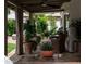 Tranquil patio featuring potted plants, outdoor seating, and a stone tiled area, ideal for relaxation at 8068 E Del Trigo Rd, Scottsdale, AZ 85258