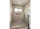 Shower featuring a frameless glass door, gold fixtures, and white mosaic tile at 8068 E Del Trigo Rd, Scottsdale, AZ 85258