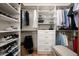 Well-organized walk-in closet with shelves, hanging rods, drawers, and a variety of clothing and accessories at 8068 E Del Trigo Rd, Scottsdale, AZ 85258