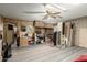 Large carpeted basement with brick walls, and wood paneling with a drop ceiling and ceiling fan at 8602 N 41St Ave, Phoenix, AZ 85051