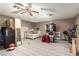 Spacious carpeted basement with brick walls, neutral colors, ceiling fan, and furniture at 8602 N 41St Ave, Phoenix, AZ 85051