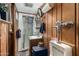 Small bathroom featuring wood panelling, corner shower, and vintage style fixtures at 8602 N 41St Ave, Phoenix, AZ 85051