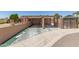 View of the home's driveway and covered parking area with a wall and ornamental steel gate at 8602 N 41St Ave, Phoenix, AZ 85051
