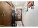 Functional laundry room featuring a washer, dryer, storage cabinets, and a door with an organizer at 8602 N 41St Ave, Phoenix, AZ 85051