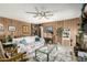 Cozy living area with wood paneling, a floral sofa, and a clear view into the adjacent kitchen at 8602 N 41St Ave, Phoenix, AZ 85051